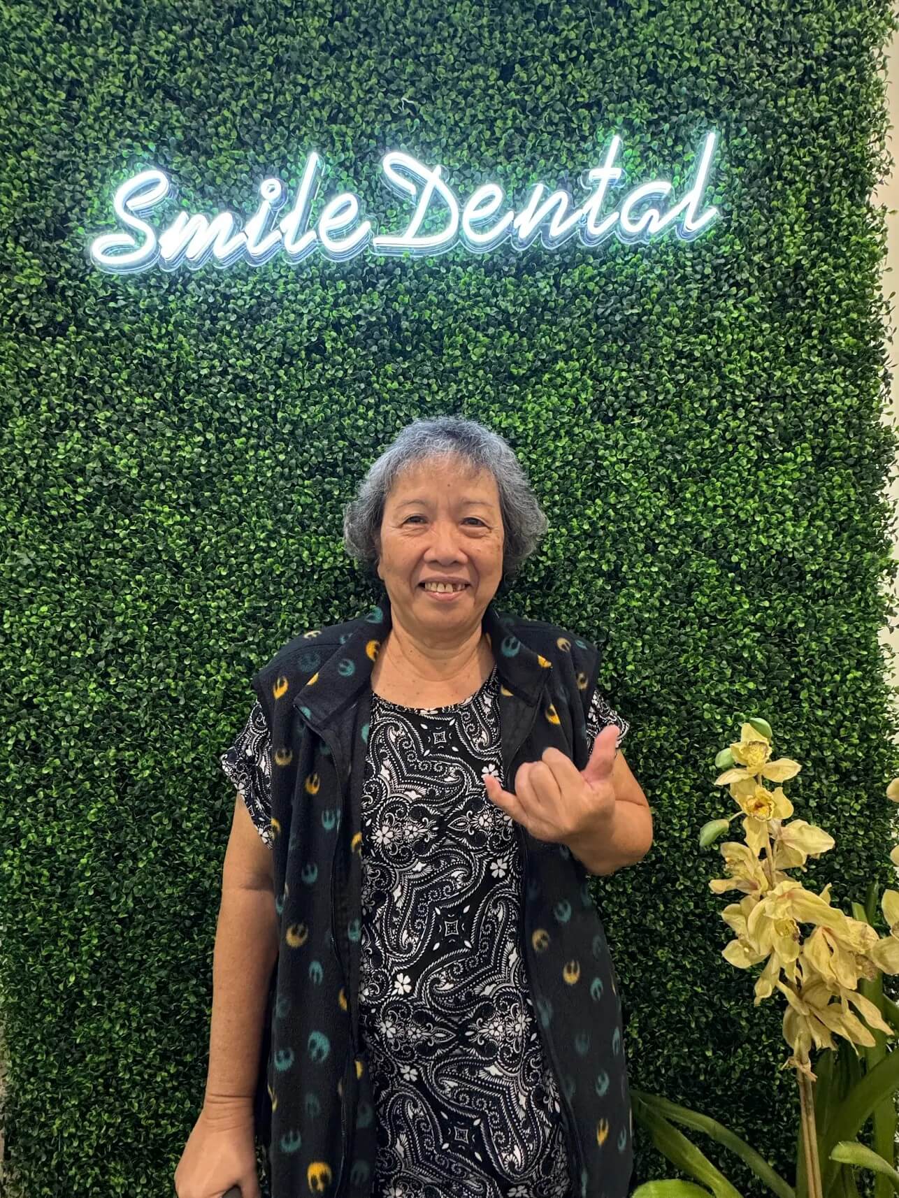 Happy patient at the Smile Dental Center wall