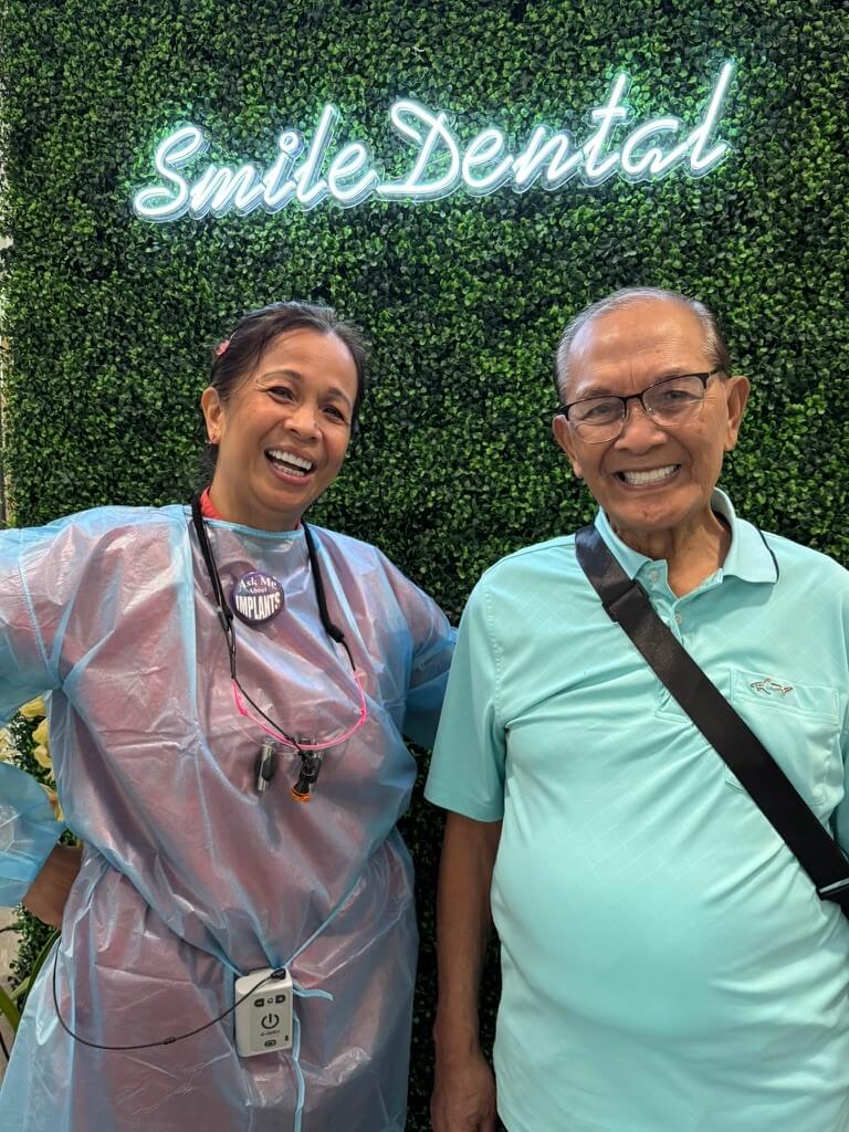 Happy patient with a Smile Dental Center team member