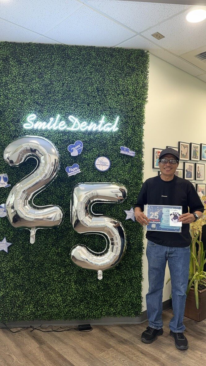 Patient celebrating Smile Dental Center's 25th anniversary