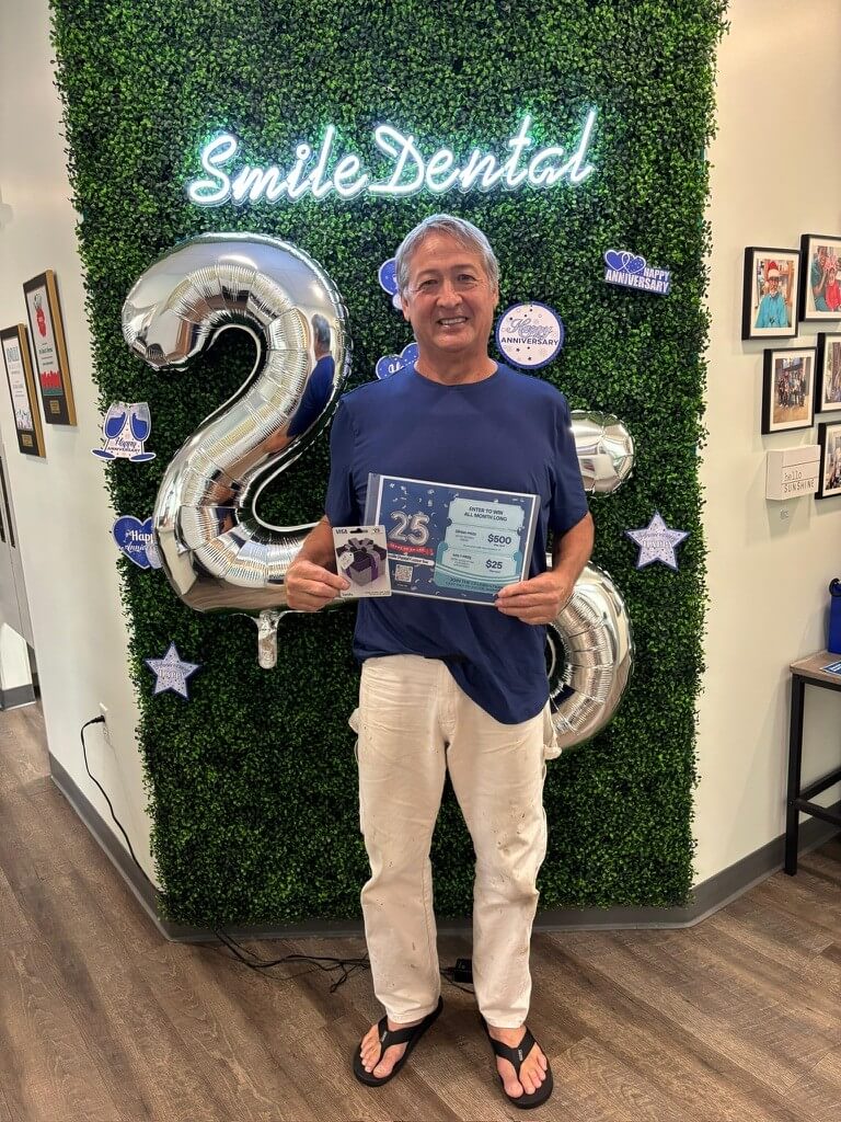 Patient celebrating 25 years of Smile Dental Center