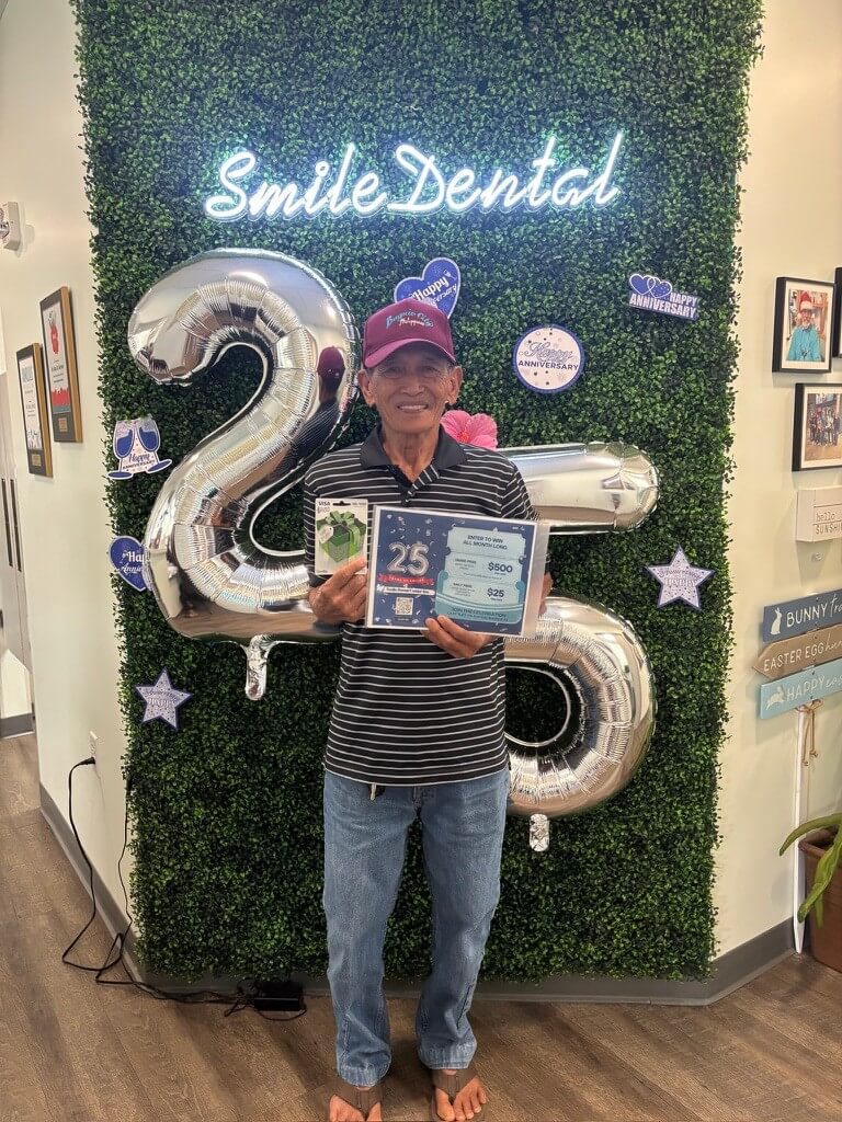 Patient with an anniversary gift card at Smile Dental Center