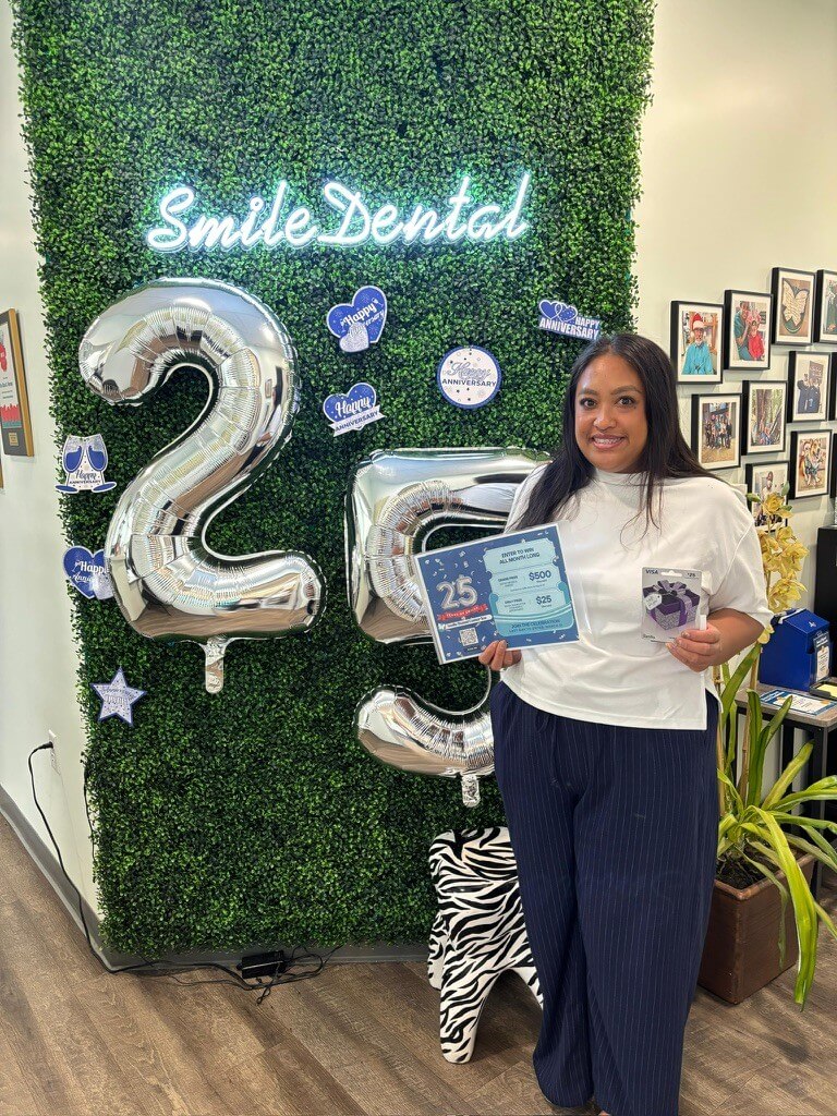 Patient holding an anniversary giveaway at Smile Dental Center