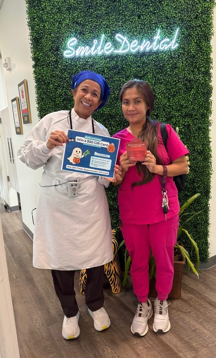 Smile Dental Center team members with a gift-card giveaway