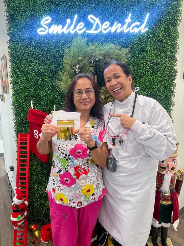 A happy patient at our Smile Dental wall