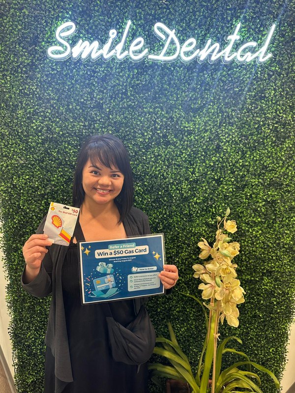 A happy patient with a prize at our office