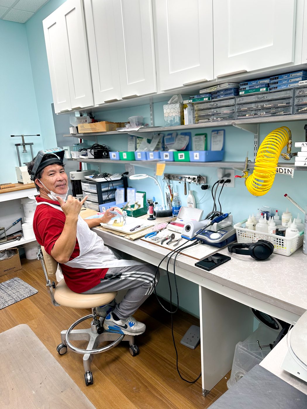 Our denture technician finishing a denture in our in-house lab